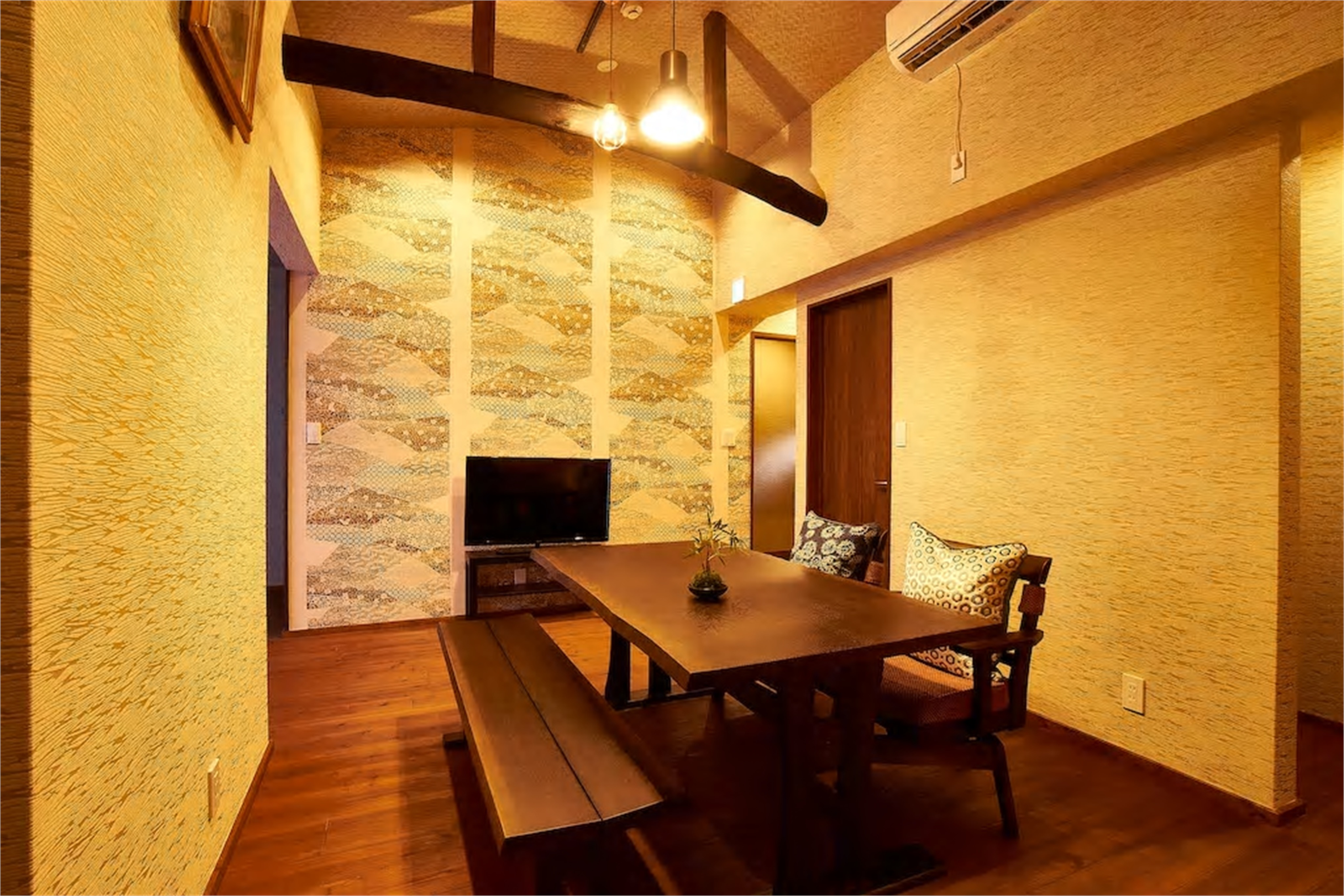 High-ceilinged living area with traditional wooden beams